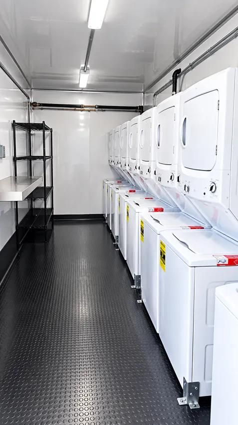 Commercial washer and dryer units inside a temporary laundry facility