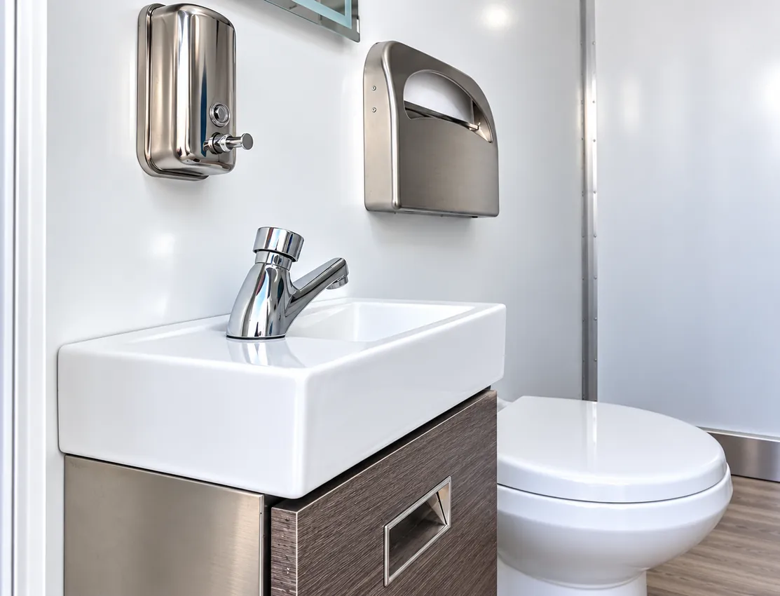 Sink and toilet inside a temporary restroom facility